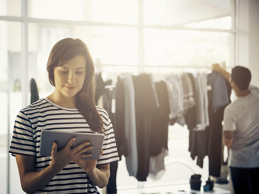 Woman using attendant tablet in store